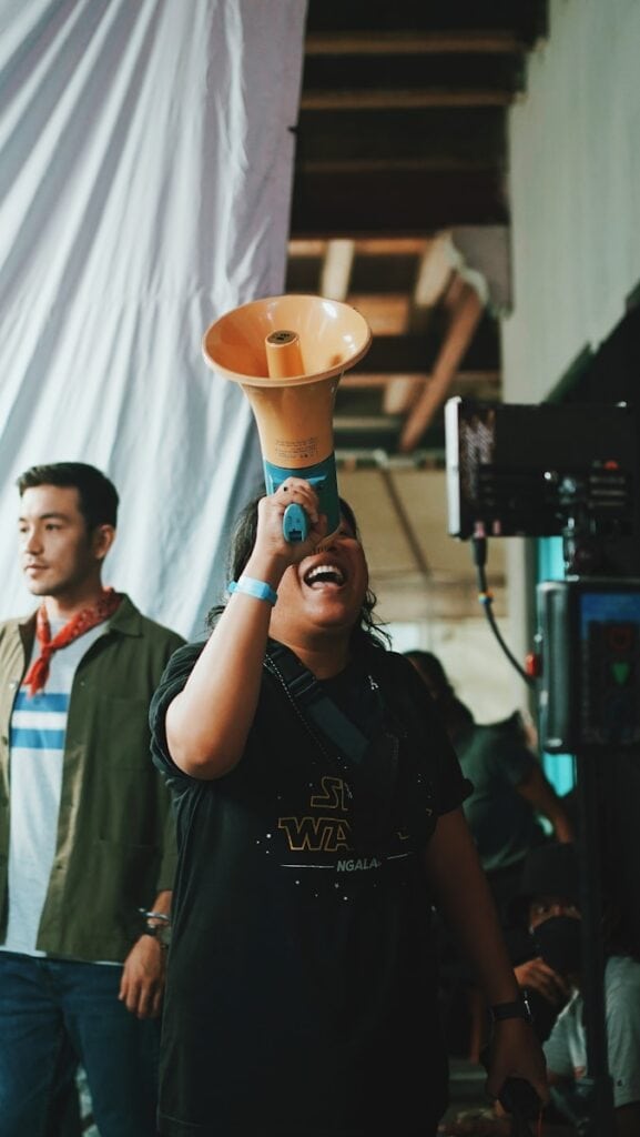 Photo by Rendy Novantino - Advertising Raleigh a woman is holding up a vase on her head