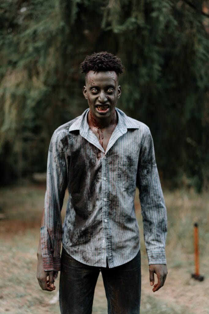 Photo by cottonbro studio - Advertising Raleigh Zombie figure with bloodied shirt in a dark forest, perfect for horror themes.
